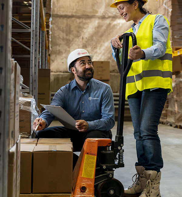 Industrial worker in protective uniform operating forklift in bi