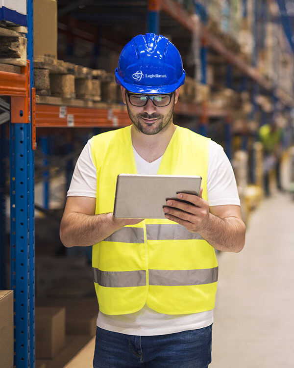 Industrial worker in protective uniform operating forklift in bi